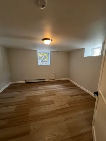 a view of a room with wooden floor and window