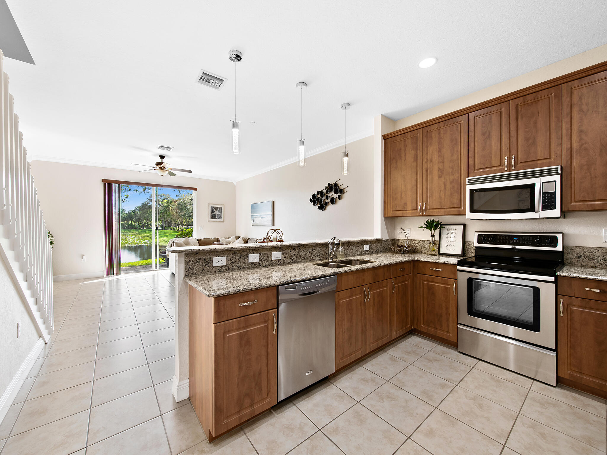 4792 Sundance Way, Unit 4792 Davie, FL 33328 - Photo 24 of 25 a large kitchen with a stove sink and microwave