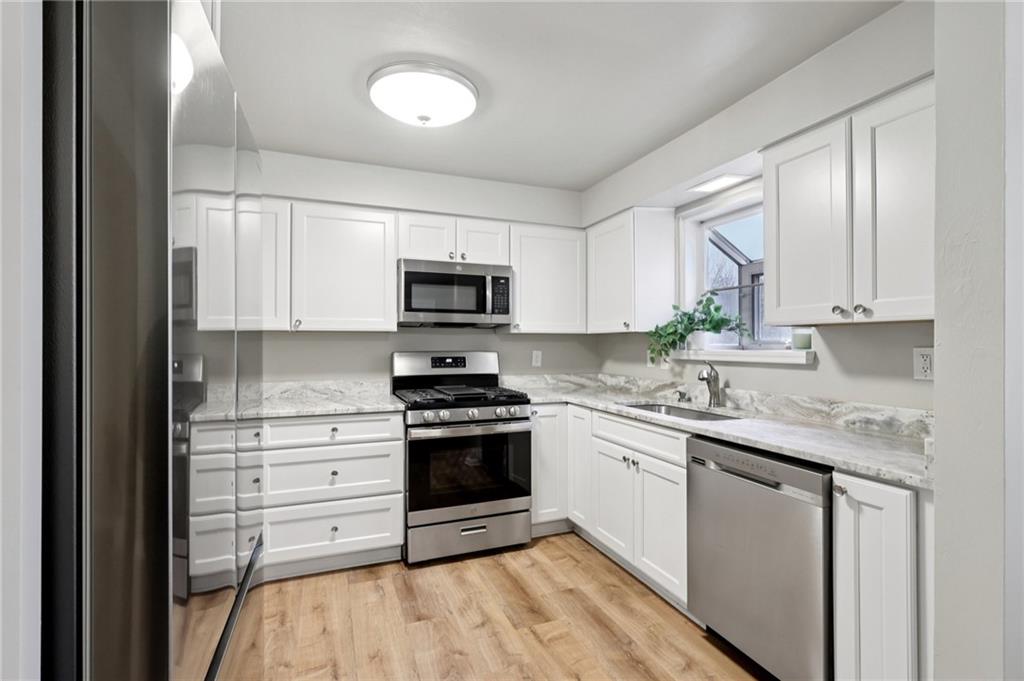 5374 Hardt Road Gibsonia, PA 15044 - Photo 12 of 49 a kitchen with stainless steel appliances granite countertop a stove a sink and a microwave
