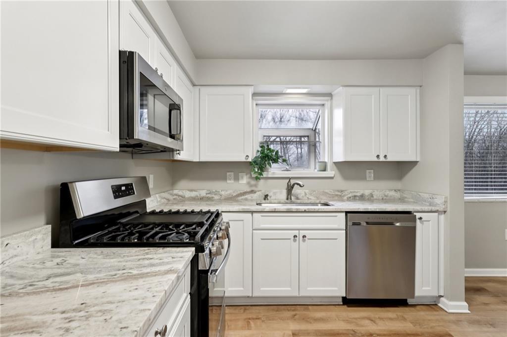 5374 Hardt Road Gibsonia, PA 15044 - Photo 14 of 49 a kitchen with stainless steel appliances granite countertop a sink stove and cabinets