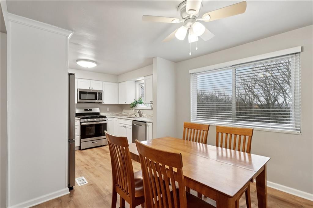 5374 Hardt Road Gibsonia, PA 15044 - Photo 8 of 49 a kitchen with stainless steel appliances granite countertop a stove a refrigerator a kitchen island with a dining table and chairs