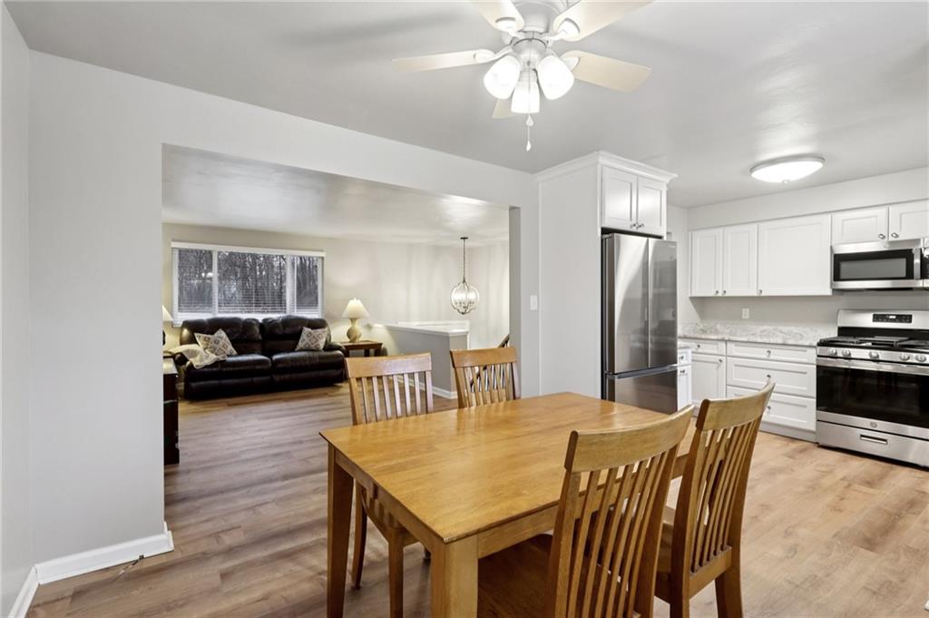 5374 Hardt Road Gibsonia, PA 15044 - Photo 9 of 49 a kitchen with stainless steel appliances kitchen island granite countertop a refrigerator a stove a kitchen island with a dining table and chairs