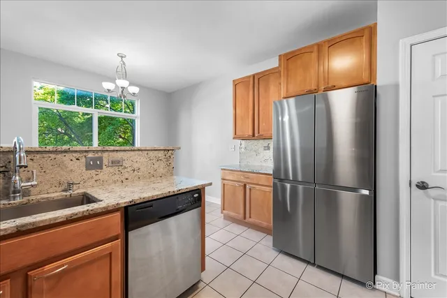 a kitchen with granite countertop a stove a sink and a microwave