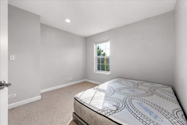 a bedroom with a bed and hallway