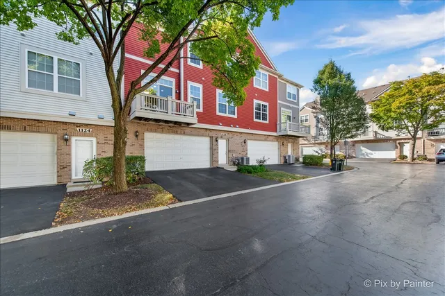 a front view of a house with a yard and a garage