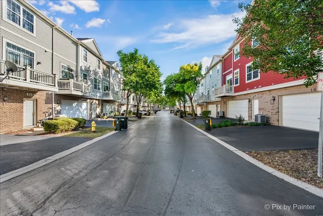 a front view of a residential apartment building with a yard
