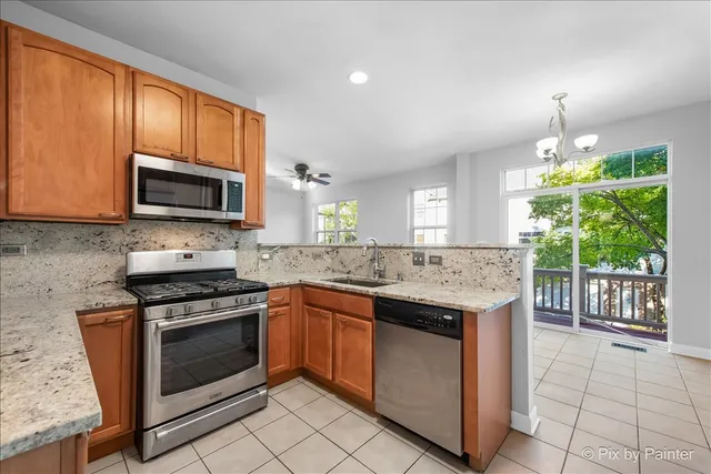 a kitchen with stainless steel appliances granite countertop a stove sink microwave and cabinets