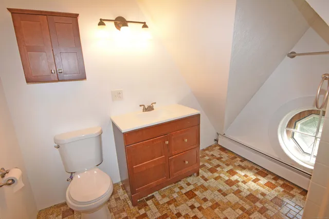 a bathroom with a toilet sink and mirror