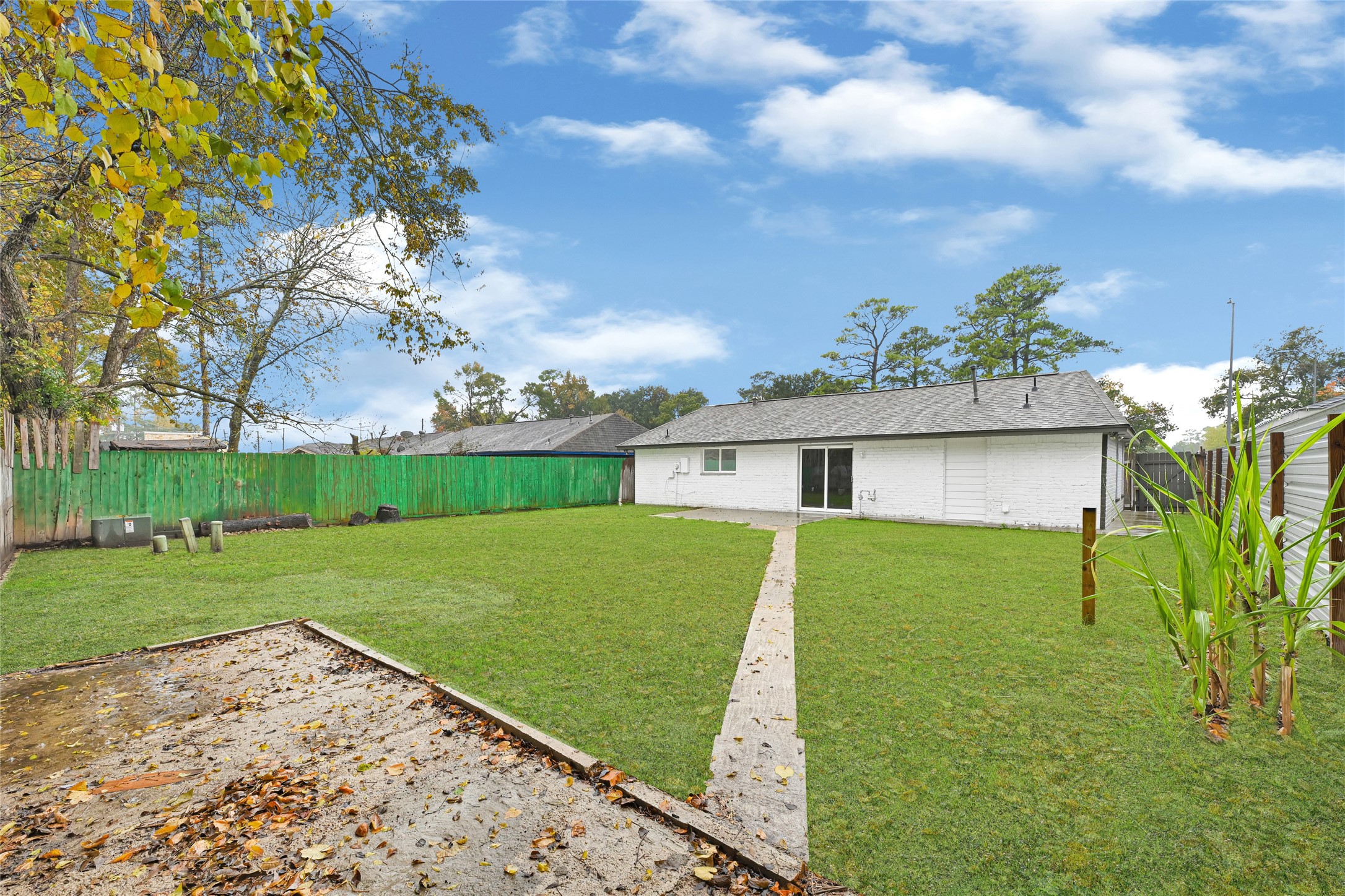 10842 Cheeves Drive Houston, TX 77016 - Photo 23 of 24 a view of a backyard with a garden
