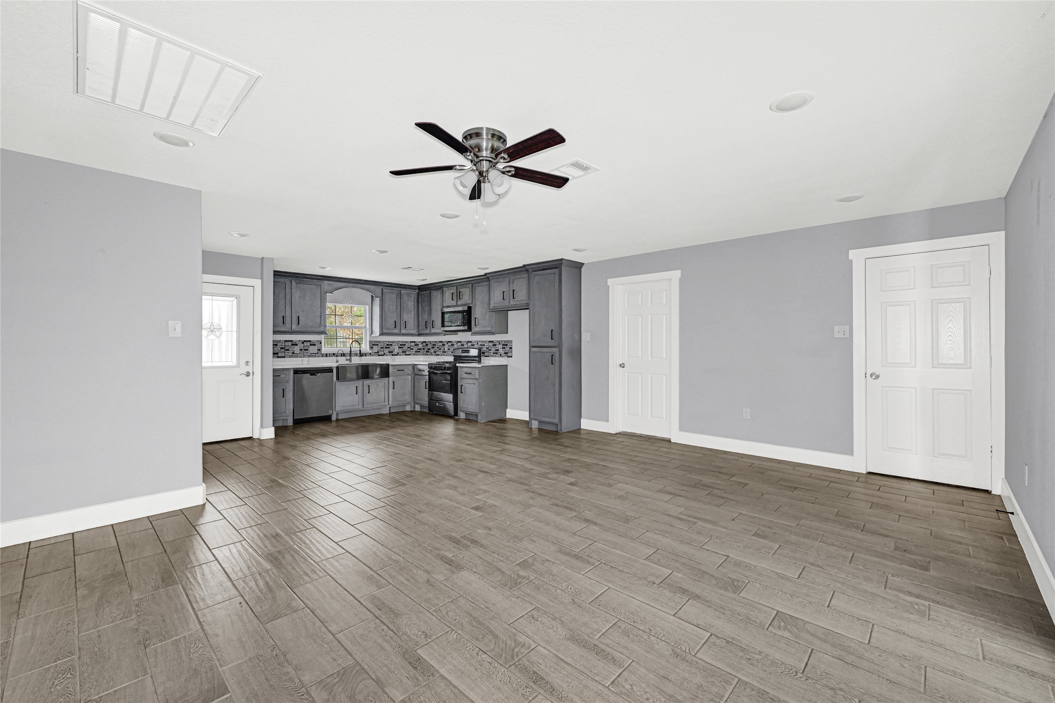 10842 Cheeves Drive Houston, TX 77016 - Photo 6 of 24 a view of a kitchen with a sink stove cabinets and empty room