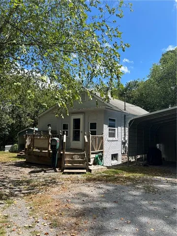 a view of a house with a large tree