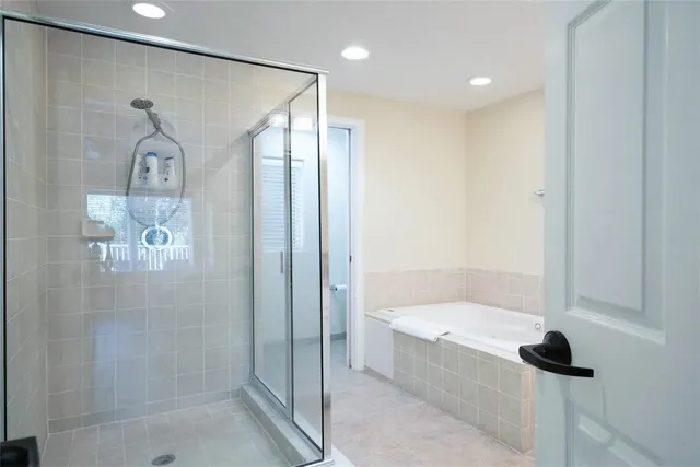 a bathroom with a bathtub and a shower