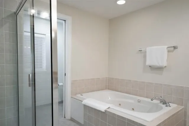 a bathroom with a bathtub and shower