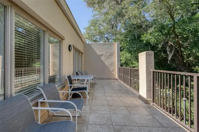 a view of a patio with a table and chairs and wooden floor