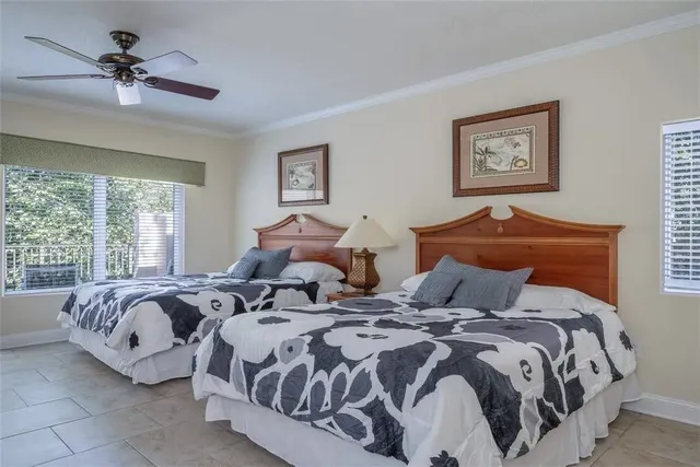 a bedroom with two beds and a chandelier