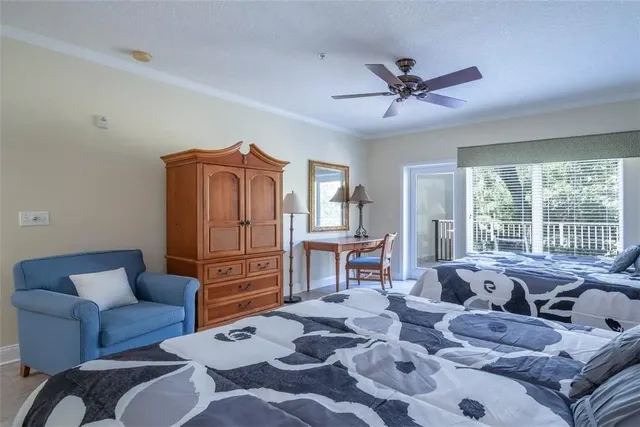 a living room with furniture ceiling fan and a window