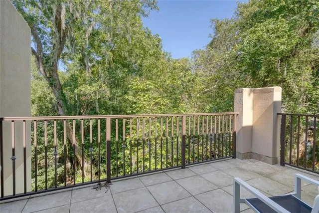 a balcony with trees in front of it