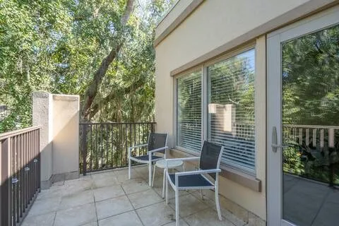 a view of a house with backyard and sitting area