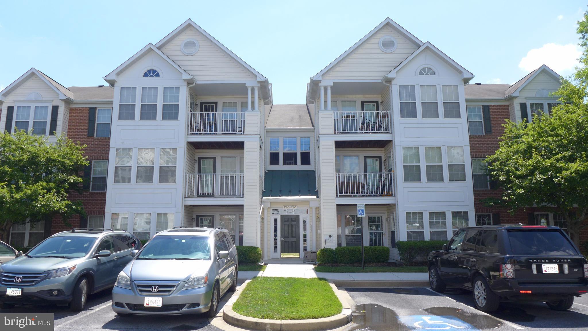 9746 Reese Farm Road, Unit 9746 Owings Mills, MD 21117 - Photo 1 of 22 a front view of a building with cars parked