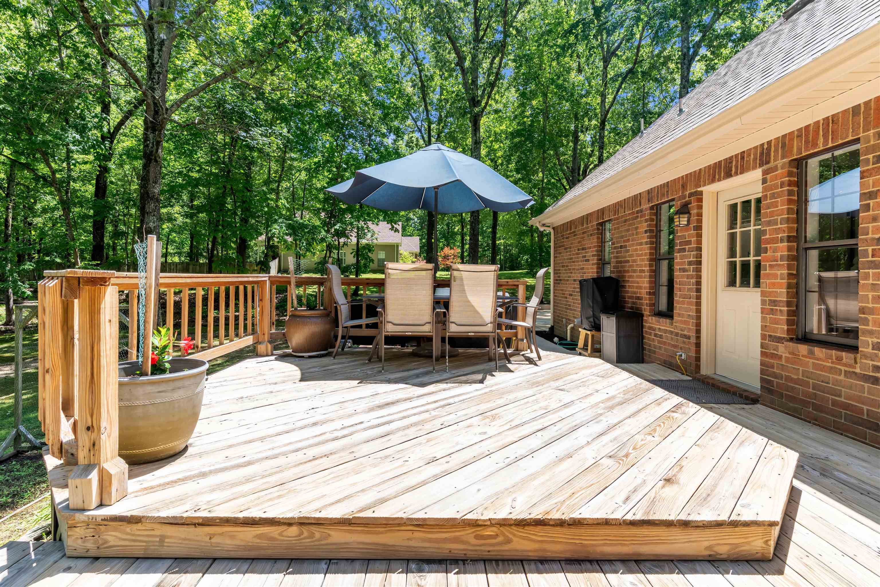 400 Great Oaks Road Eads, TN 38028 - Photo 37 of 40 Spacious outdoor deck with natural wood planks, wood railing, and a brick exterior wall