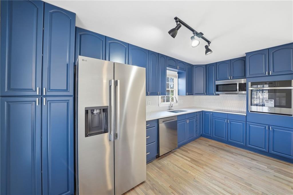 2810 Shaw Road Marietta, GA 30066 - Photo 11 of 38 a kitchen with stainless steel appliances granite countertop a refrigerator a sink and wooden cabinets