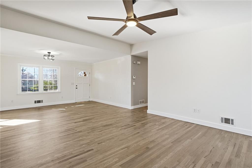 2810 Shaw Road Marietta, GA 30066 - Photo 15 of 38 an empty room with wooden floor ceiling fan and windows