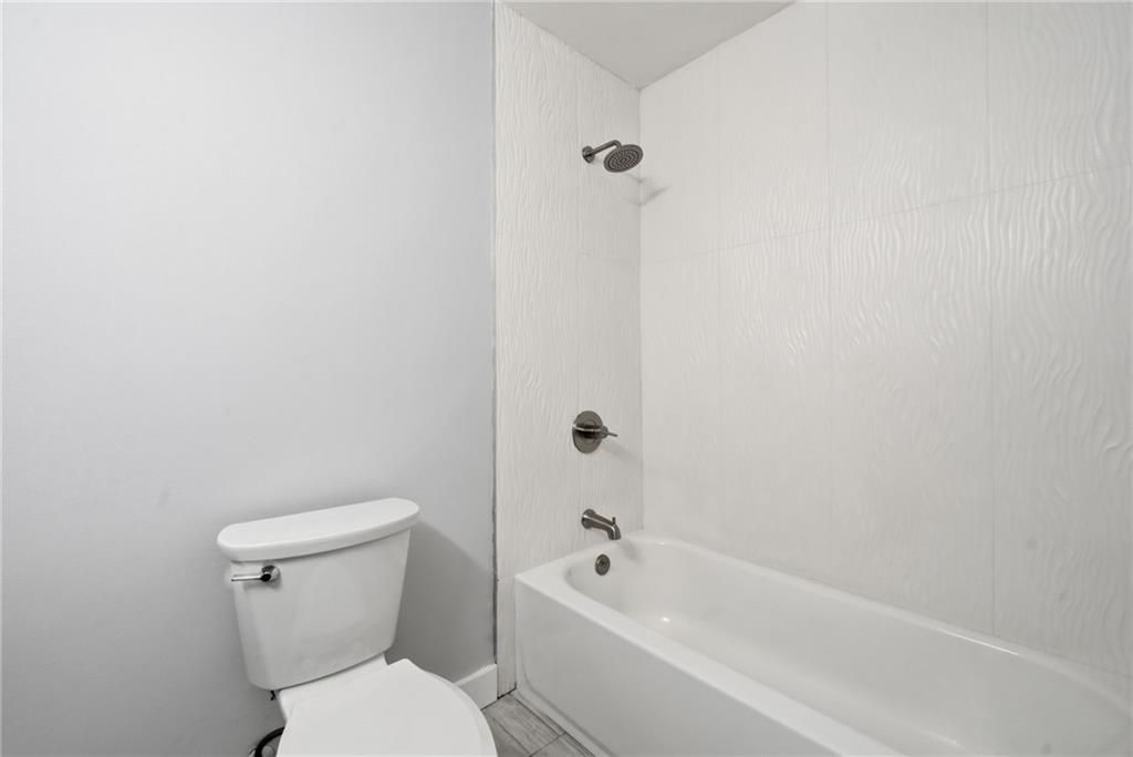 2810 Shaw Road Marietta, GA 30066 - Photo 17 of 38 a white toilet sitting next to a bath tub