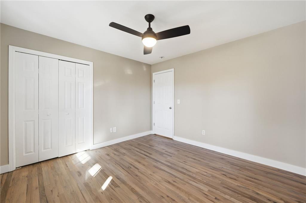 2810 Shaw Road Marietta, GA 30066 - Photo 25 of 38 an empty room with wooden floor and chandelier fan
