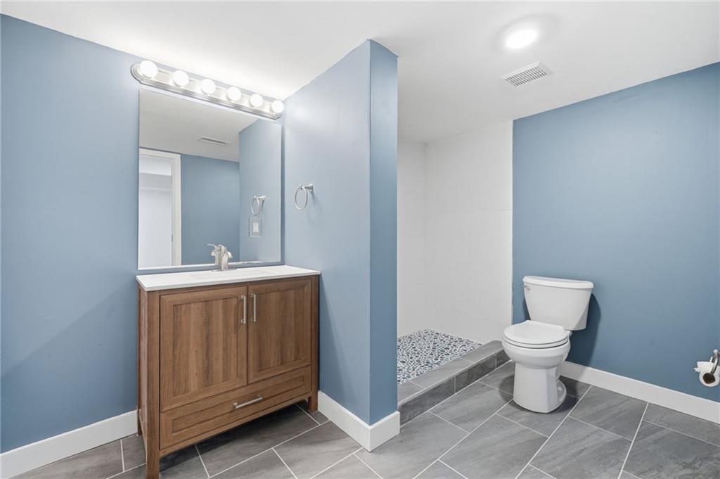 2810 Shaw Road Marietta, GA 30066 - Photo 29 of 38 a bathroom with a toilet sink and mirror