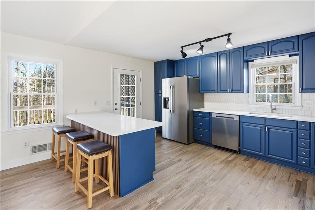 2810 Shaw Road Marietta, GA 30066 - Photo 9 of 38 a kitchen with stainless steel appliances a refrigerator and wooden cabinets
