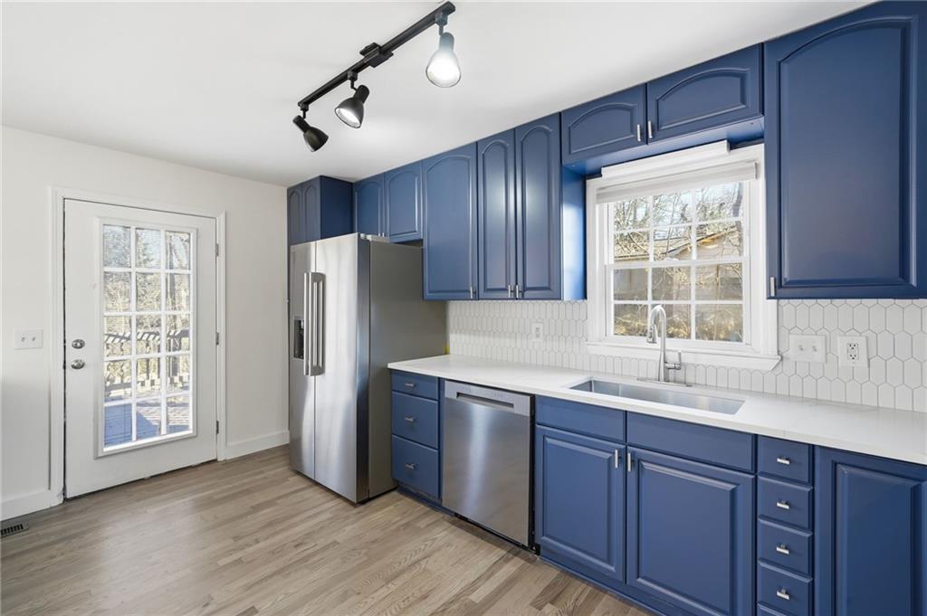 2810 Shaw Road Marietta, GA 30066 - Photo 10 of 38 a kitchen with stainless steel appliances granite countertop a refrigerator a sink a stove and wooden floors