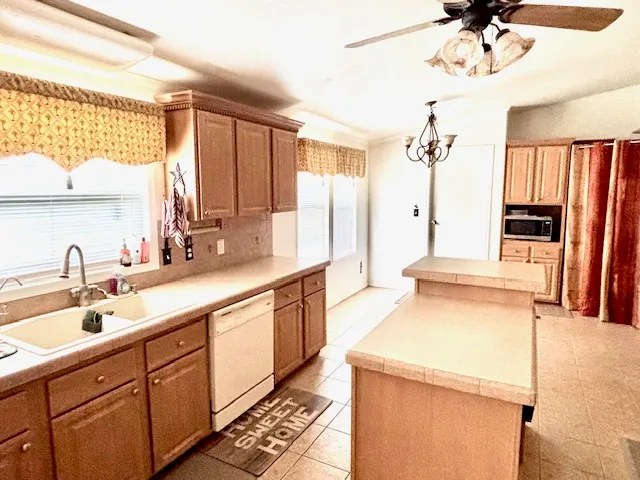 a kitchen with a sink and a refrigerator