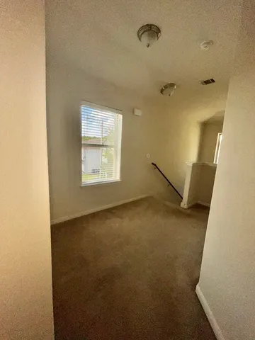 an empty room with a empty space and windows