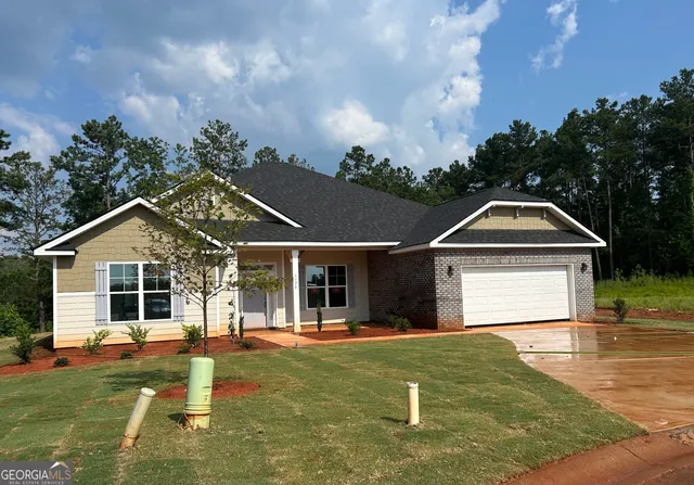 a front view of a house with garden