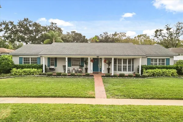 a front view of a house with a yard table and chairs