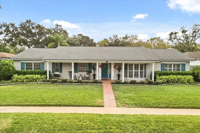 a front view of a house with a yard table and chairs
