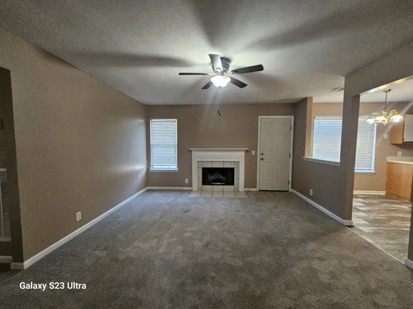 a kitchen with stainless steel appliances granite countertop a refrigerator a sink dishwasher a stove and white countertops with wooden floor