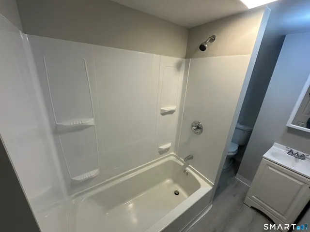 a bathroom with a tub and sink