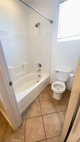 a bathroom with a bathtub and a toilet