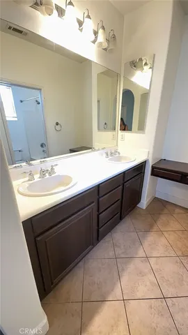 a bathroom with a sink vanity and a mirror