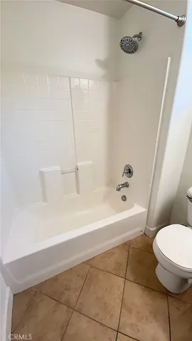 a bathroom with a bathtub and a toilet