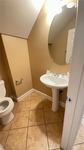 a bathroom with a sink toilet and mirror