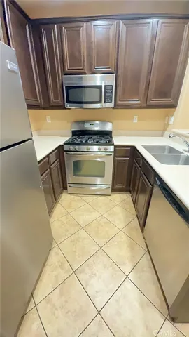 a kitchen with a stove a sink and a microwave