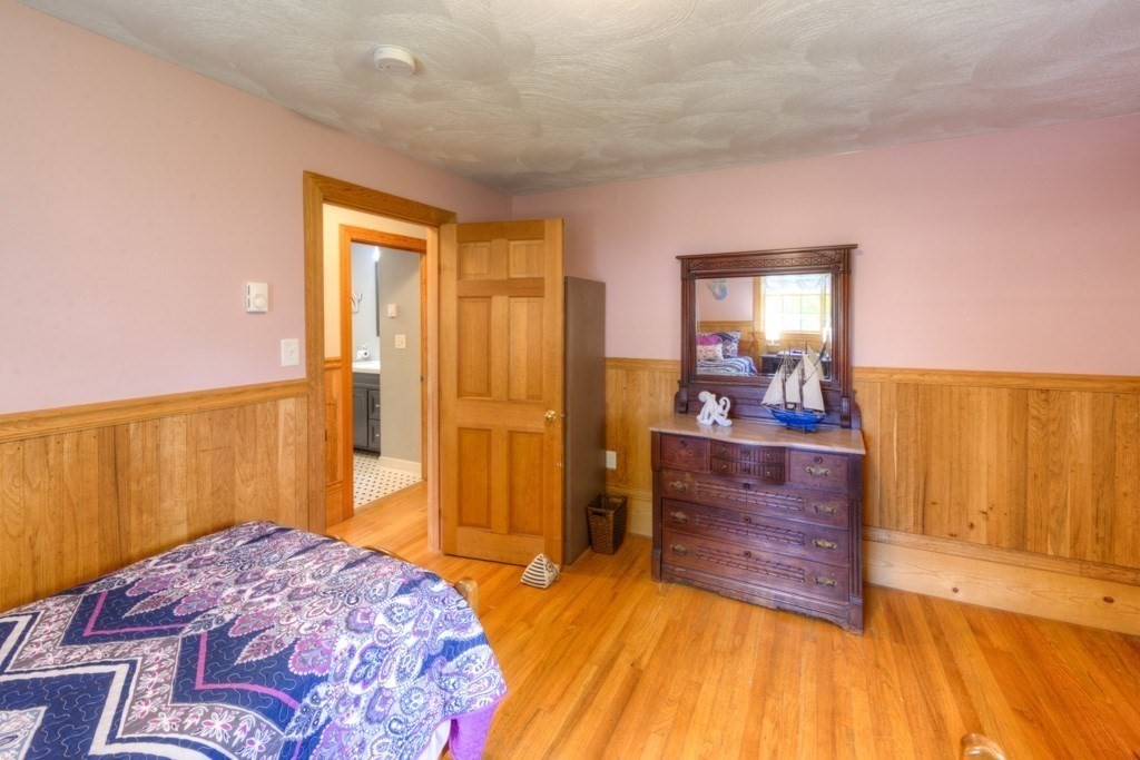 1 Factory Street Sandwich, MA 02563 - Photo 12 of 38 a bedroom with a bed and wooden floor