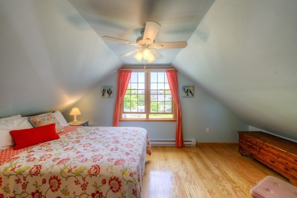 1 Factory Street Sandwich, MA 02563 - Photo 15 of 38 a bedroom with a bed and a chandelier