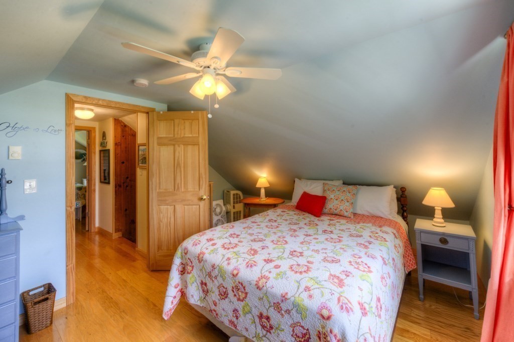 1 Factory Street Sandwich, MA 02563 - Photo 16 of 38 a bedroom with a bed and a chandelier