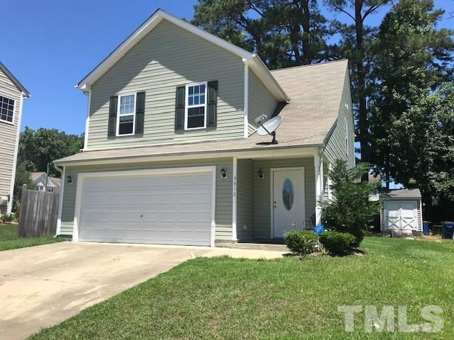3512 Rendition Street Raleigh, NC 27610 - Photo 2 of 26 a front view of a house with a yard and garage