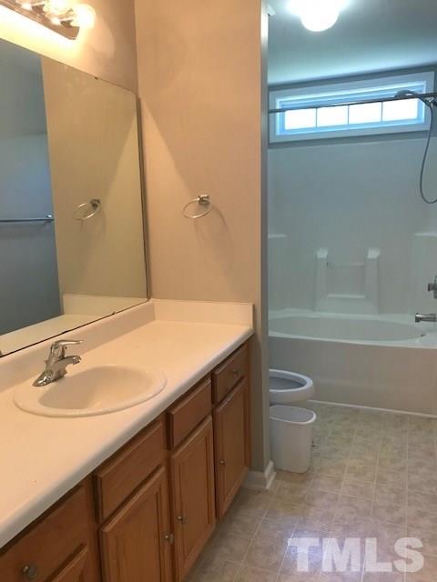3512 Rendition Street Raleigh, NC 27610 - Photo 15 of 26 a bathroom with a sink a toilet and shower