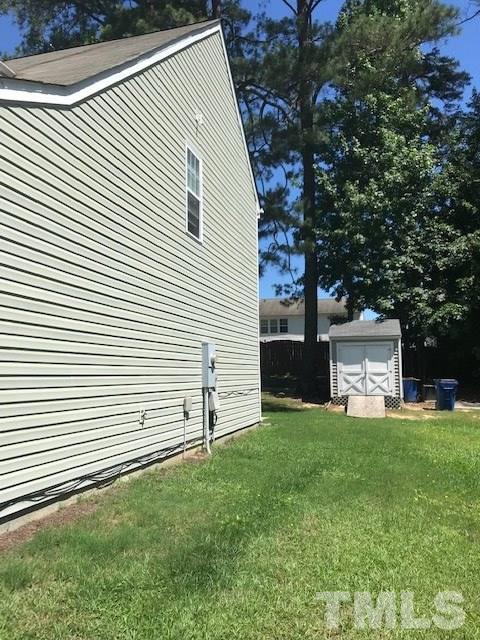 3512 Rendition Street Raleigh, NC 27610 - Photo 20 of 26 a front view of a house with a yard and garage