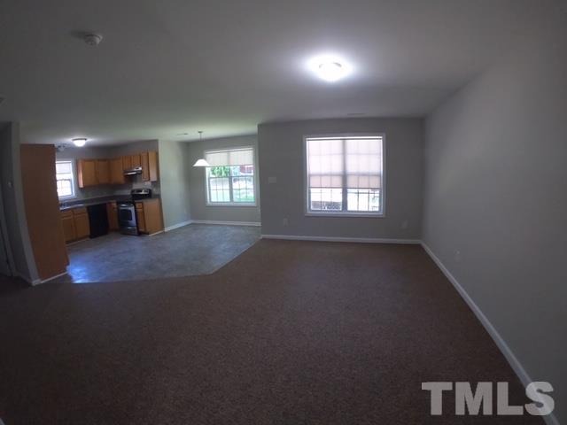 3512 Rendition Street Raleigh, NC 27610 - Photo 3 of 26 an empty room with a fireplace and windows